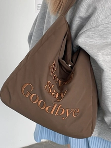 Brown canvas tote bag with 'Never Say Goodbye' embroidery for stylish daily use