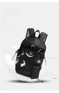 Detail shot of lightweight black hiking backpack showing feather-light fabric and large storage