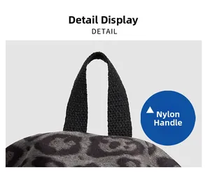 Close-up of leopard print backpack showing durable black nylon handle and soft fabric texture