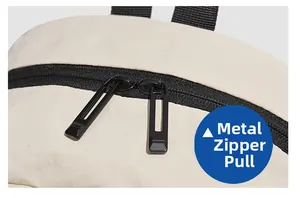 Detailed macro view of durable black hardware dual zipper pulls on beige oxford fabric