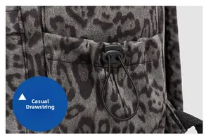 Detailed macro view of the leopard print backpack fabric with black plastic drawstring buckle