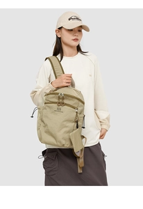 Detail of khaki hiking backpack featuring a small coin purse and wear-resistant nylon fabric