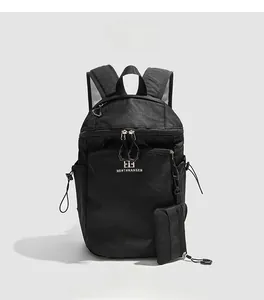 Detail view of water-resistant black hiking backpack with side pocket and accessory pouch