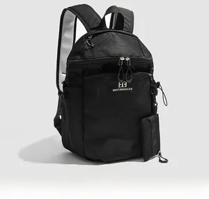 Detail view of lightweight black hiking backpack with side pocket and breathable mesh straps