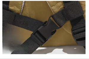 Close-up of a durable black plastic buckle and high-density nylon strap on a backpack