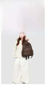Close-up of leopard print backpack with durable nylon fabric and front zipper pocket