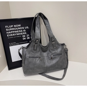 Close-up of vintage dark grey tote bag featuring matte PU texture and dual front zippers