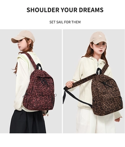 Detail view of stylish leopard print backpack showing main compartment and front pocket zoom
