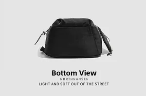 Detail view showing the durable reinforced bottom of the black nylon hiking backpack