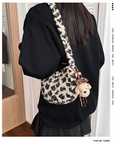 Close-up of leopard print plush crossbody bag with a cute teddy bear charm pendant