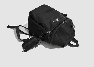 Close-up of durable black nylon hiking backpack with small side pouch and metal zipper