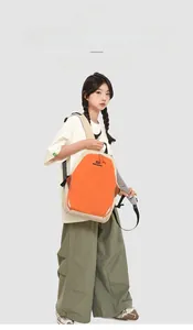 Detail of waterproof nylon backpack with orange and beige contrast and brand logo