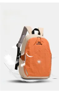 Detail of lightweight color-block backpack with orange and beige accents and floating feathers