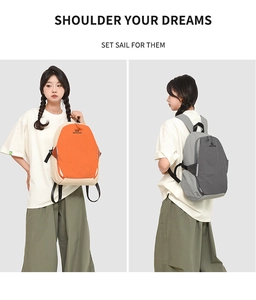 Detail view of contrast color and grey nylon backpacks with padded shoulder straps