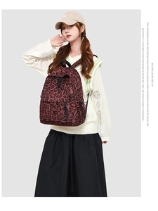Detail of leopard print backpack with drawstring closure and front zipper pocket