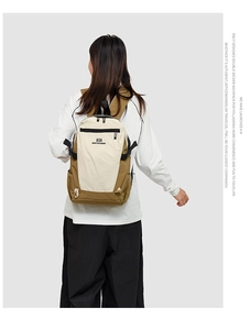 Detail view of large capacity beige and olive travel backpack with dual main compartments