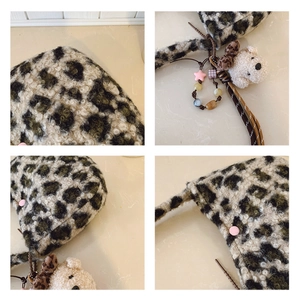 Detail of leopard print faux fur shoulder bag with cute plush bear charm and pink snap