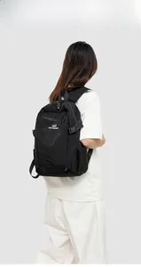 Close-up of a black Oxford travel backpack showing side buckle and brand logo