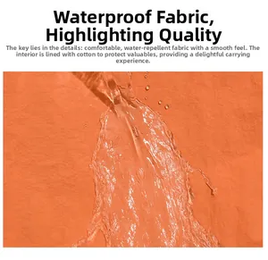 Detail of water-repellent orange fabric with water drops on the smooth padded backpack surface
