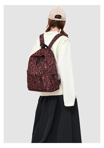 Close-up of leopard print backpack with durable canvas texture and adjustable black straps
