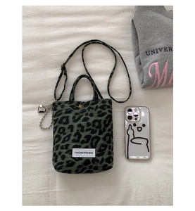 Détail du sac en toile léopard avec bandoulière réglable et pendentif en cœur