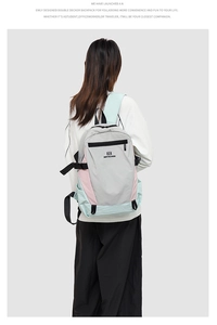 Back view of a large capacity grey oxford backpack with pink and green accents