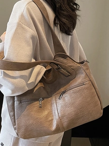 Vintage brown leather tote bag with wide shoulder strap and front zipper pocket