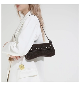 Detail view of coffee suede shoulder bag with silver rivet studs on the flap