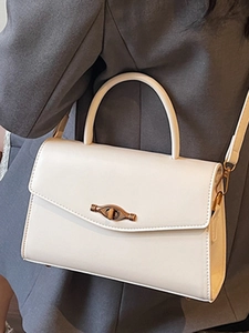 Elegant off-white rectangular crossbody handbag with vintage bronze twist lock for women