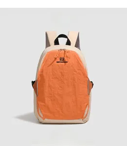 Front detail of beige and orange colorblock backpack with mesh straps and logo
