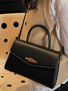 Elegant black leather square handbag with golden twist lock and adjustable shoulder strap