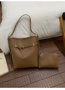 Close-up of brown litchi pattern leather bucket bag set with decorative buckle strap
