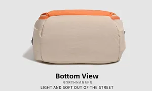 Detailed bottom view of the contrast color nylon backpack showing durable orange piping
