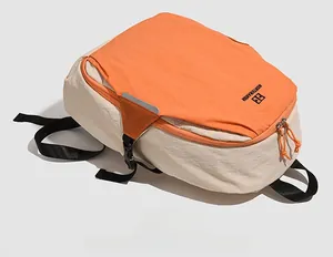 Detail view of the orange and beige contrast backpack with Northnansen logo and side buckles