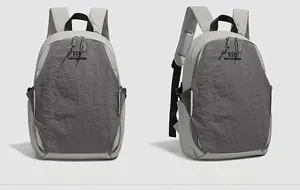 Front and side macro views of grey backpack featuring pleated texture and brand logo