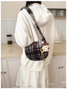 Detail of grey plaid plush crossbody bag featuring soft fuzzy texture and cute teddy bear charm