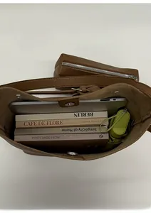 Top view of large brown bucket bag interior showing capacity for laptop and books