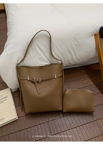 Detail of dark brown lychee textured leather bucket bag set with inner zipper pouch