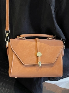Vintage brown leather crossbody bag with white stitching and gold hardware detail