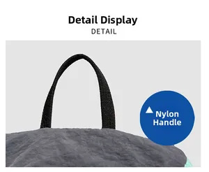 Detail view of durable black nylon handle and dark grey wrinkled fabric texture