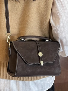 Vintage dark brown crossbody bag with white stitching and gold hardware for women