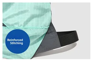 Detail view of hiking backpack with bartack reinforcement on green ripstop fabric