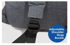 Detail of adjustable gray backpack shoulder strap with durable black plastic buckle