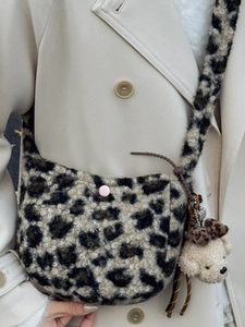 Plush leopard print crossbody bag with pink button and cute teddy bear charm pendant