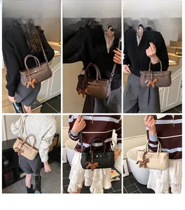 Detail view of lychee leather handbags with metal strap buckles and horse charms