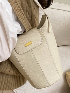 Sac seau minimaliste en cuir grainé beige avec détails dorés et bandoulière