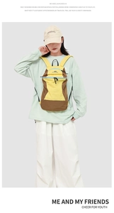 Detail view of a yellow and brown outdoor backpack with blue zippers on a studio model