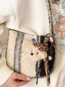 Cute fuzzy plush crossbody bag with striped pattern and a small teddy bear decoration