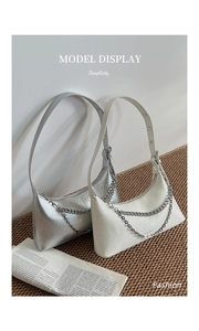 Close-up of silver and beige pleated hobo bags with metallic chain detail and branded logo