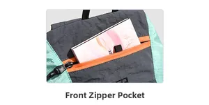 Detailed shot of the front zipper pocket on a multi-color hiking backpack with a notebook